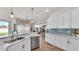 Kitchen featuring marble countertops, stainless steel appliances, and a view of the living room at 2917 Blackwater Creek Dr, Lakeland, FL 33810