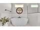 Freestanding tub in bright bathroom with large window, art, modern fixtures, and tiled accent wall at 2985 Pickards Pass, Lakeland, FL 33813