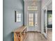 Inviting entryway with wood-look tile flooring, a console table, and a view into other rooms at 2985 Pickards Pass, Lakeland, FL 33813