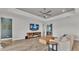 Spacious living room featuring modern wood floors, a ceiling fan, and a tray ceiling at 2985 Pickards Pass, Lakeland, FL 33813