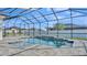 Sparkling screened-in pool with a waterfall feature and stone pavers at 2985 Pickards Pass, Lakeland, FL 33813