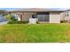 Single-story home boasts a well-manicured lawn and inviting screened-in porch at 3203 Bear Creek Ln, Lakeland, FL 33810