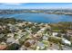 An aerial shot showing a neighborhood and lake, with houses surrounded by lush trees at 324 Lake Mariam Blvd, Winter Haven, FL 33884