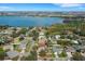 An aerial view showcasing a neighborhood near a serene lake, surrounded by lush greenery and homes at 324 Lake Mariam Blvd, Winter Haven, FL 33884