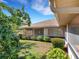 The backyard features lush landscaping, a screened patio, and manicured lawn at 324 Lake Mariam Blvd, Winter Haven, FL 33884
