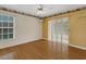 Bright bedroom featuring hardwood floors, ceiling fan, and sliding glass door at 324 Lake Mariam Blvd, Winter Haven, FL 33884