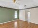 This carpet-free bedroom features a vaulted ceiling, a window, and a doorway to another room at 324 Lake Mariam Blvd, Winter Haven, FL 33884