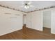 Bright bedroom features hardwood floors, ceiling fan, and hallway access at 324 Lake Mariam Blvd, Winter Haven, FL 33884