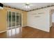 Bright bedroom with hardwood floors, sliding door access to patio, and decorative wallpaper border at 324 Lake Mariam Blvd, Winter Haven, FL 33884