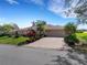 Charming single-story home with a well-manicured lawn, lush landscaping, and a spacious two-car garage at 324 Lake Mariam Blvd, Winter Haven, FL 33884