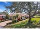 Landscaped home with a lush lawn, mature trees, a long driveway, and vibrant plantings at 324 Lake Mariam Blvd, Winter Haven, FL 33884