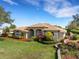 Charming single-story home with lush landscaping, a well-manicured lawn, and an inviting entrance at 324 Lake Mariam Blvd, Winter Haven, FL 33884