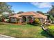 Charming single-story home with a manicured lawn, mature landscaping, and a brick walkway at 324 Lake Mariam Blvd, Winter Haven, FL 33884