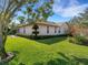 Exterior home view features manicured lawn, trim landscaping, and stone accents at 324 Lake Mariam Blvd, Winter Haven, FL 33884