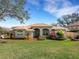 Landscaped front yard featuring a charming home with a well-manicured lawn and lush plantings at 324 Lake Mariam Blvd, Winter Haven, FL 33884