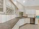 Bright kitchen featuring neutral paint, granite countertops, white cabinets, and stainless steel appliances at 324 Lake Mariam Blvd, Winter Haven, FL 33884