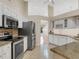 Bright kitchen features stainless steel appliances, granite countertops, tile floor, and lots of counter space at 324 Lake Mariam Blvd, Winter Haven, FL 33884