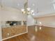 Open living space with hardwood floors, chandelier, and kitchen pass-through at 324 Lake Mariam Blvd, Winter Haven, FL 33884