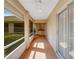 Screened-in patio featuring tile floors, a ceiling fan, and outdoor kitchen with scenic backyard views at 324 Lake Mariam Blvd, Winter Haven, FL 33884