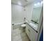 Clean bathroom with a modern vanity, granite countertop, white cabinets, and a shower-tub combo with tiled walls at 3291 Alberta St, Bartow, FL 33830