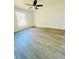 Bright bedroom featuring light gray floors, a ceiling fan, and a window letting in natural light at 3291 Alberta St, Bartow, FL 33830