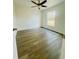 Bright bedroom featuring modern wood flooring, a ceiling fan, and a window letting in natural light at 3291 Alberta St, Bartow, FL 33830