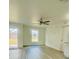 Cozy living room featuring light gray floors, a ceiling fan, and a window letting in natural light at 3291 Alberta St, Bartow, FL 33830