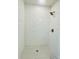 Detail shot of a stylish shower with white subway tile, mosaic floor, and bronze hardware at 3291 Alberta St, Bartow, FL 33830