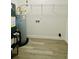 Utility room equipped with modern water heater, HVAC system, and wire shelving at 3291 Alberta St, Bartow, FL 33830