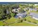 Aerial view of home, highlighting a screened pool, spacious backyard, lush landscaping, and a tranquil neighborhood setting at 335 Osprey Landing Way, Lakeland, FL 33813