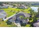 Expansive aerial view of the home with a beautifully landscaped yard, lush greenery, and a serene lake nearby at 335 Osprey Landing Way, Lakeland, FL 33813