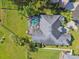 Aerial view showcasing pool and spa and the home's roof and backyard at 335 Osprey Landing Way, Lakeland, FL 33813