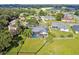 Aerial view of a beautiful home featuring a screened-in pool, spacious backyard, and well-maintained landscaping at 335 Osprey Landing Way, Lakeland, FL 33813