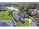 Aerial view of a stunning home, showcasing its well-maintained yard and proximity to a beautiful lake and lush greenery at 335 Osprey Landing Way, Lakeland, FL 33813