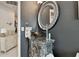 Stylish bathroom featuring black vessel sink, a stylish vanity, and round mirror at 335 Osprey Landing Way, Lakeland, FL 33813