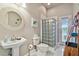 Bathroom featuring a glass block shower, neutral walls, and bright natural light at 335 Osprey Landing Way, Lakeland, FL 33813