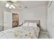 Neutral bedroom with closet, ceiling fan and view into hall with accent table at 335 Osprey Landing Way, Lakeland, FL 33813