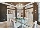 Elegant dining room with a crystal chandelier, modern glass table, and stylish decor at 335 Osprey Landing Way, Lakeland, FL 33813