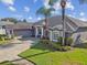 Beautiful home with an attached garage and well-manicured lawn and lovely landscaping at 335 Osprey Landing Way, Lakeland, FL 33813