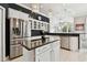 A kitchen featuring stainless steel refrigerator, white cabinets, granite counters, and a center island at 335 Osprey Landing Way, Lakeland, FL 33813