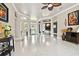 Expansive living room with tile floors, neutral walls, and seamless flow to dining area, perfect for entertaining at 335 Osprey Landing Way, Lakeland, FL 33813