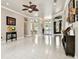 Bright living room with ceiling fan, recessed lights, and an elegant entryway offers plenty of natural light at 335 Osprey Landing Way, Lakeland, FL 33813