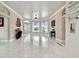 Bright and airy living room with tiled flooring, large windows, and an open floor plan at 335 Osprey Landing Way, Lakeland, FL 33813