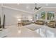 Living room with tile floors, neutral paint, a ceiling fan, and large windows for natural light at 335 Osprey Landing Way, Lakeland, FL 33813