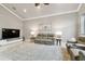 Living room features tile floors, neutral paint, lamps and a decorative rug under the sofas at 335 Osprey Landing Way, Lakeland, FL 33813