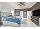 Beautiful main bedroom with a luxury bed, ceiling fan, and access to other rooms at 335 Osprey Landing Way, Lakeland, FL 33813