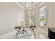 Home office featuring tile flooring, large windows, and a modern glass desk at 335 Osprey Landing Way, Lakeland, FL 33813