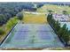 Aerial view of tennis courts surrounded by green landscaping and golf course at 335 Osprey Landing Way, Lakeland, FL 33813