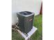 Goodman air conditioner outside home sits on cement pad surrounded by grass and a white wall at 362 Pasco Ct, Winter Haven, FL 33884