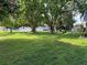 Large grassy backyard featuring mature trees that offer plenty of shade at 362 Pasco Ct, Winter Haven, FL 33884